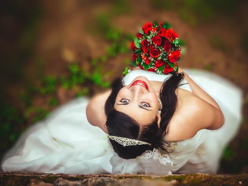 bride holding a bouquet of roses