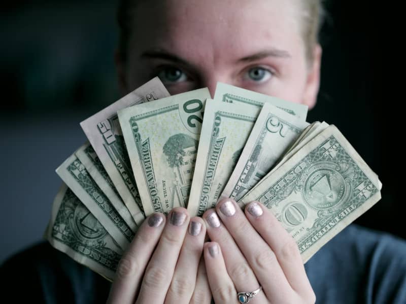 young woman holding money